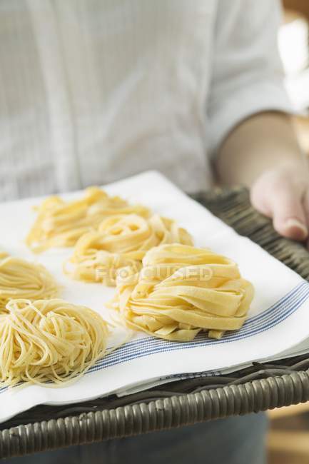 Person holding different types of pasta — Stock Photo
