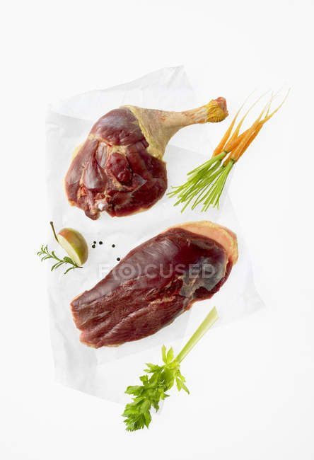 Raw goose pieces on paper — Stock Photo