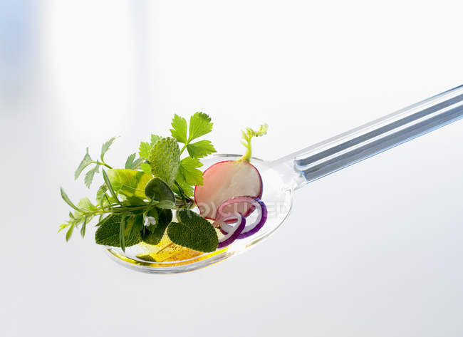 Closeup view of assorted herbs and salad ingredients on a salad server — Stock Photo