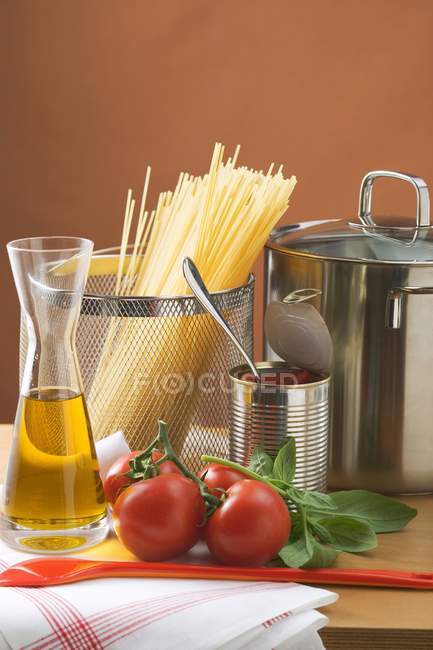 Dried spaghetti pasta and fresh tomatoes — Stock Photo