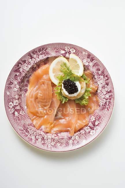 Smoked salmon with caviar and sour cream — Stock Photo