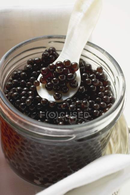 Black caviar in jar — Stock Photo