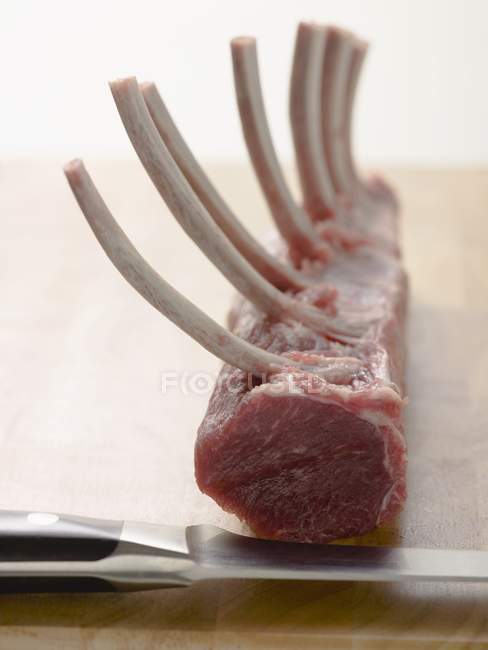 Raw Rack of lamb on chopping board — Stock Photo