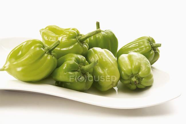 Green peppers on platter — Stock Photo