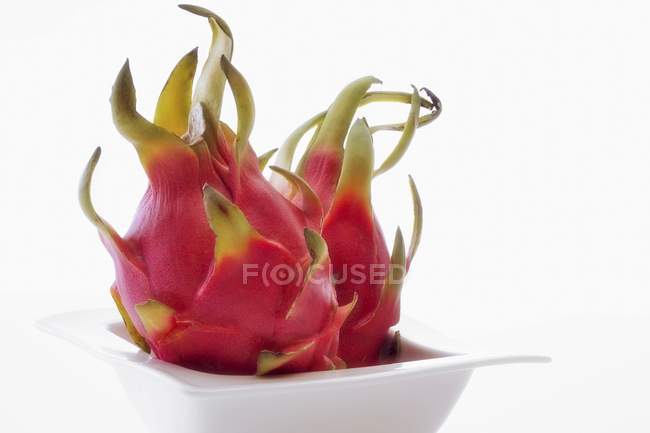 Fresh pink pitahayas in bowl — Stock Photo