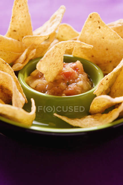 Vue rapprochée de la puce Tortilla trempée dans la salsa de tomate — Photo de stock