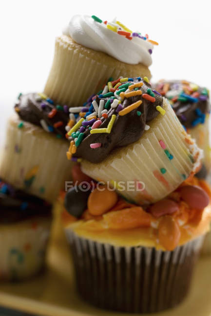 Colorful decorated muffins in pile — Stock Photo