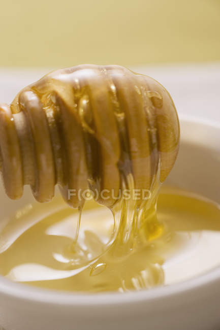 Honey running from dipper — Stock Photo