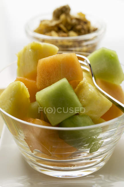 Exotic fruit salad in glass bowl — Stock Photo