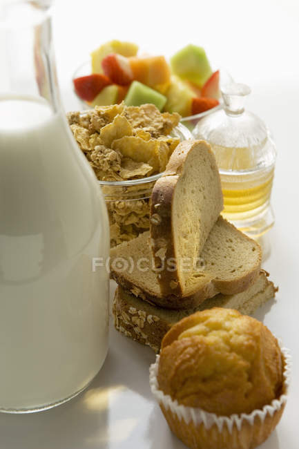 Breakfast ingredients on white surface — Stock Photo
