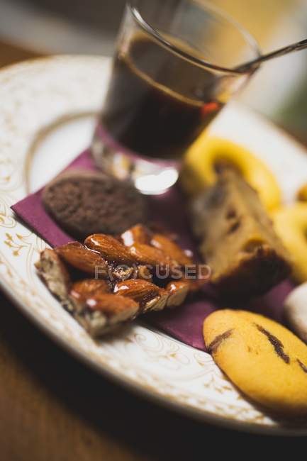 Glass of espresso and assorted biscuits — Stock Photo