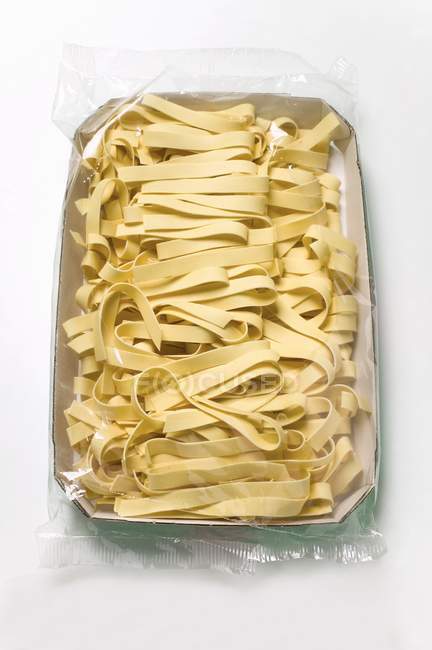 Dried Pappardelle pasta in packaging — Stock Photo