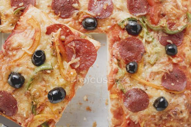 Sliced pepperoni pizza with peppers — Stock Photo