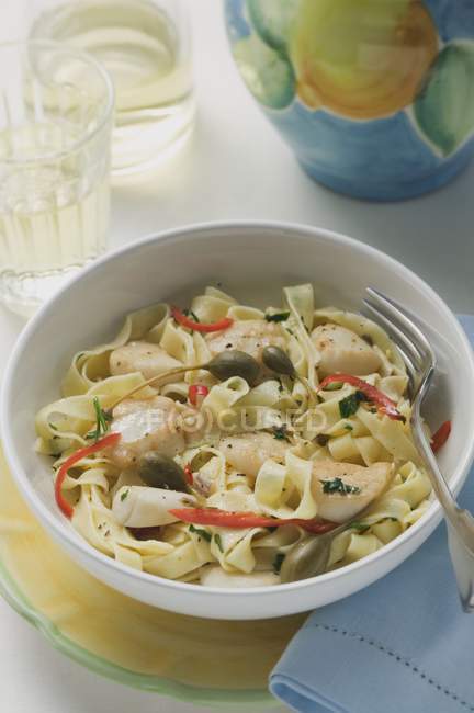 Ribbon pasta with fish and capers — Stock Photo