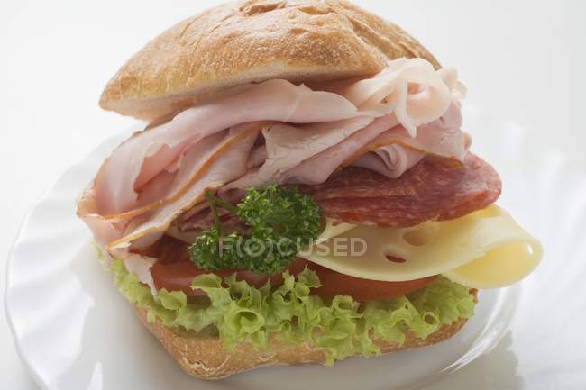 Bread roll filled with ham — Stock Photo