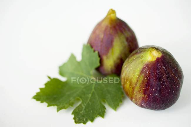 Two figs with leaf — Stock Photo