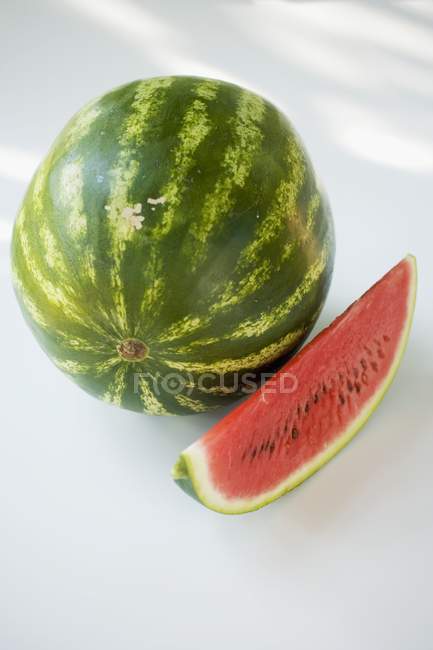 Watermelon with fresh ripe slice — Stock Photo