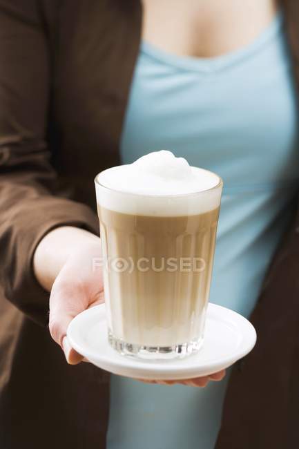Woman holding latte macchiato — Stock Photo
