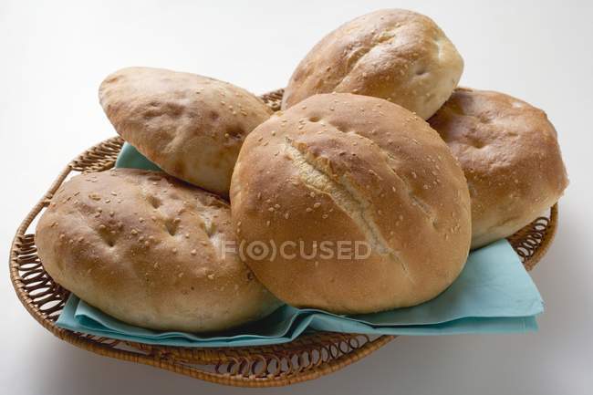 Sesame buns in bread basket — Stock Photo