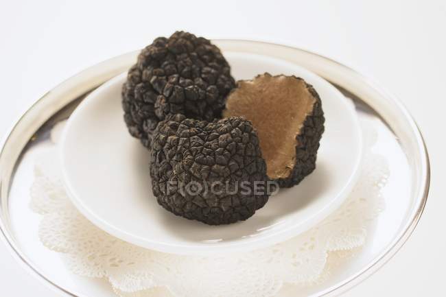 Black truffles, whole and halved — Stock Photo