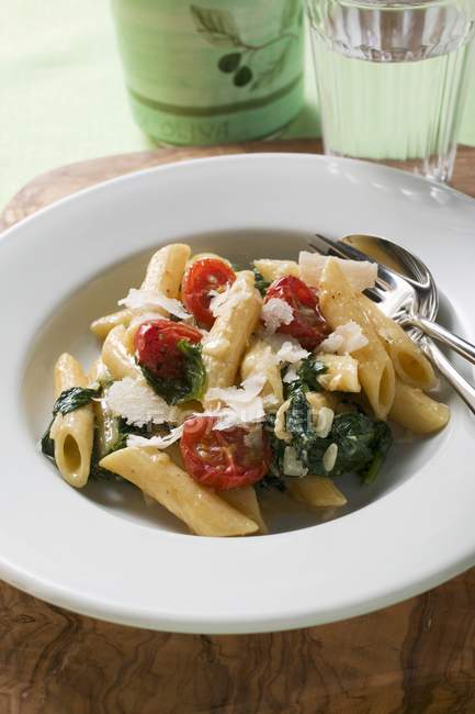 Penne pasta with spinach and cocktail tomatoes — Stock Photo