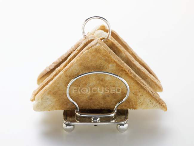 Closeup view of triangle toasts in toast rack — Stock Photo