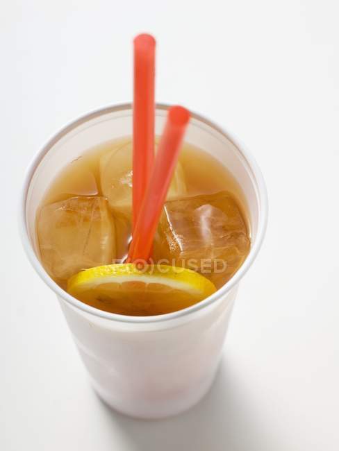 Iced tea with lemon in plastic cup — Stock Photo