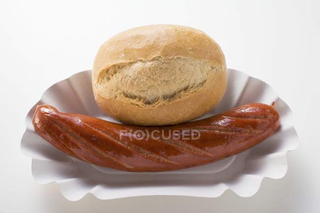Bratwurst Sausage and baguette roll — Stock Photo