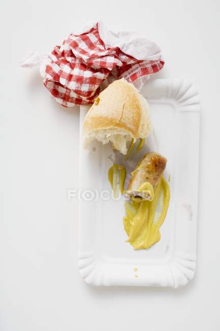 Remains of sausage with mustard — Stock Photo