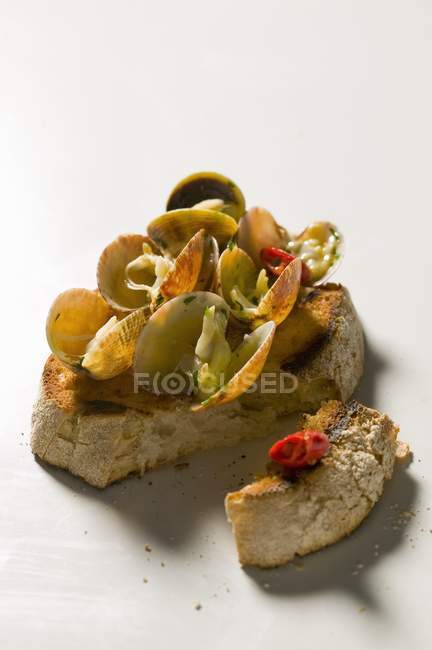 Bruschetta with clams on surface — Stock Photo