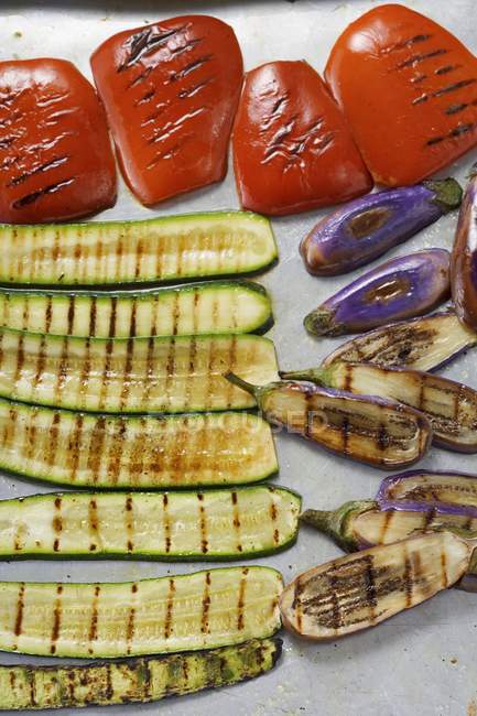 A selection of grilled vegetables on white marble surface — Stock Photo