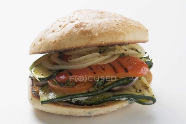Toasted roll filled with grilled vegetables  on white background — Stock Photo