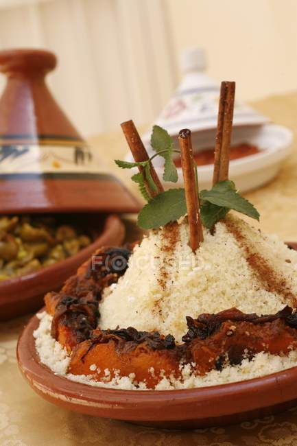 Couscous with vegetables served in tajine — Stock Photo