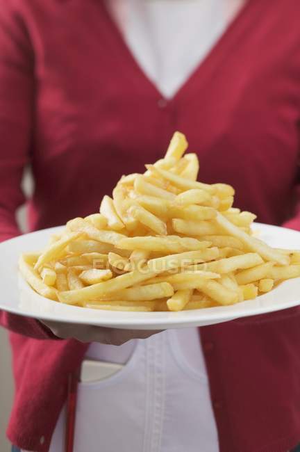 Waitress serving fried potato chips — Stock Photo