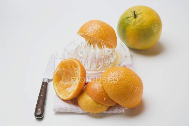 Pressage d'oranges coupées en deux — Photo de stock