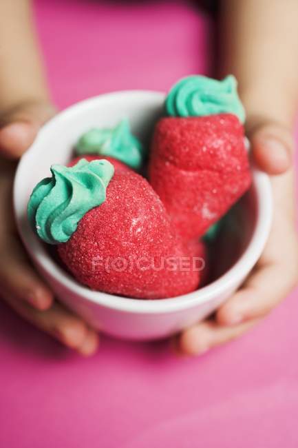 Kid holding sugar strawberries — Stock Photo