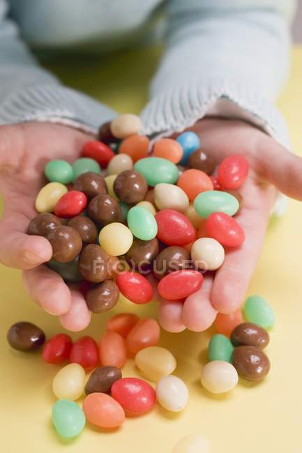 Hands holding sugar eggs — Stock Photo