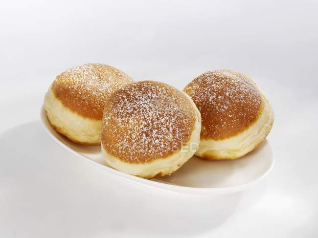 Three doughnuts on plate — Stock Photo