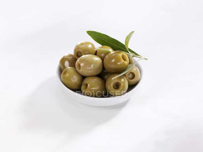 Green olives in small bowl — Stock Photo