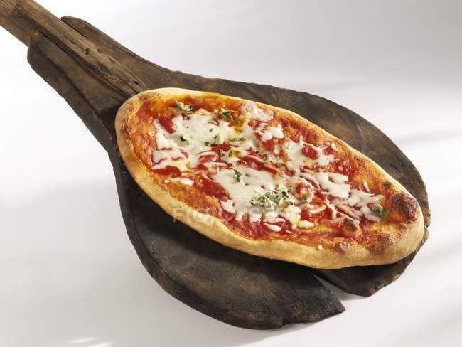 Pizza Margherita on wooden board — Stock Photo