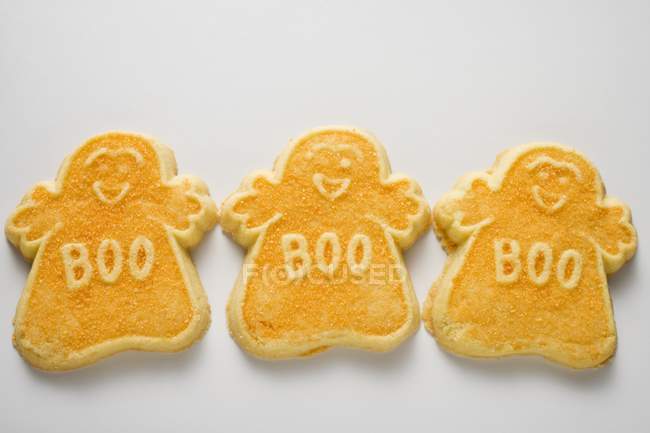 Three orange ghost biscuits — Stock Photo