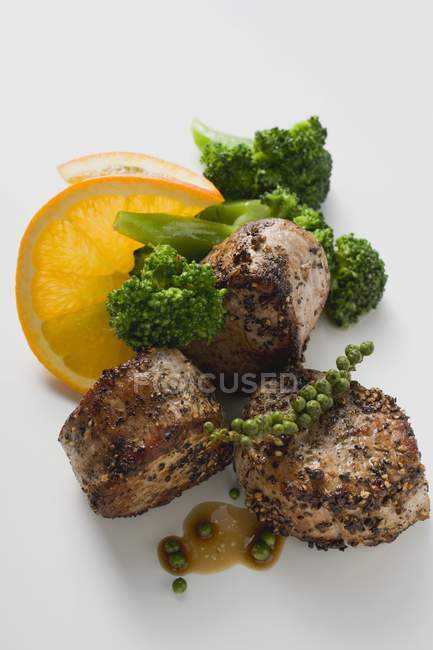 Pork medallions with green peppercorns — Stock Photo