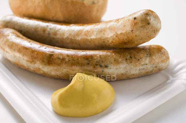 Sausages with mustard and bread roll — Stock Photo