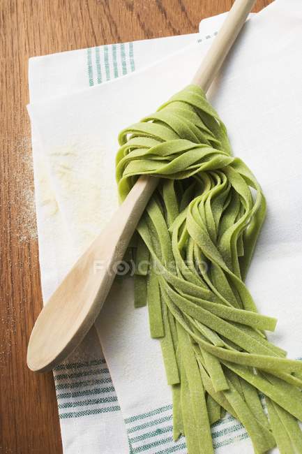 Ribbon pasta wrapped around spoon — Stock Photo