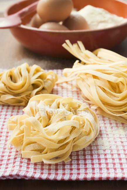 Three dried ribbon pasta nests — Stock Photo