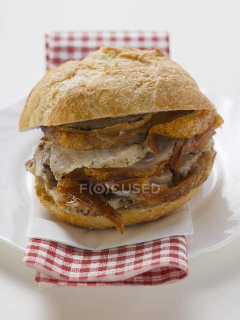 Close up of Sliced roast pork in a roll — Stock Photo
