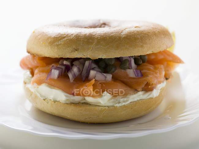 Salmon, cheese and capers in a bagel — Stock Photo