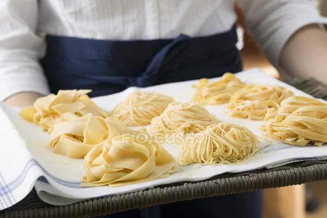 Three types of ribbon pasta on tray — Stock Photo