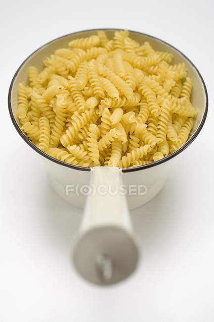 Dried Fusilli pasta in strainer — Stock Photo