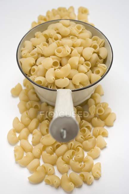Dried Lumaconi pasta in strainer — Stock Photo